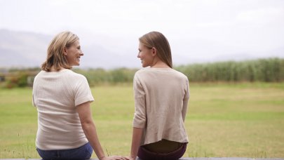 Mother and daughter sitting and together